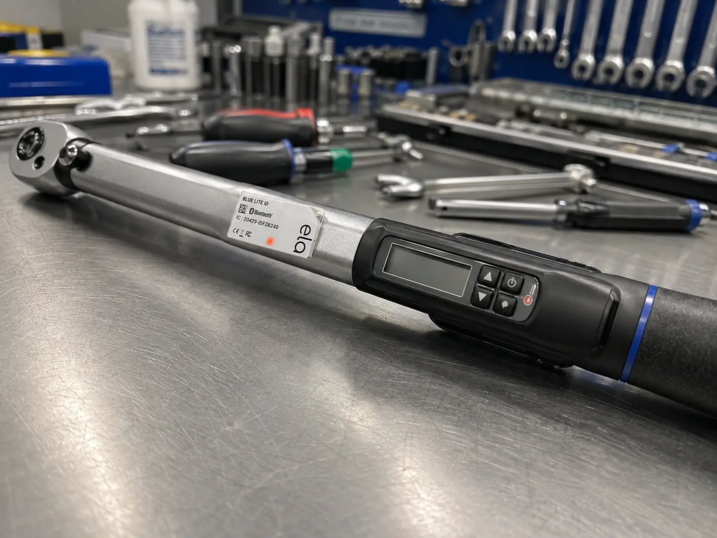 Pressure-sensitive adhesive — small asset tag on a precision hand tool